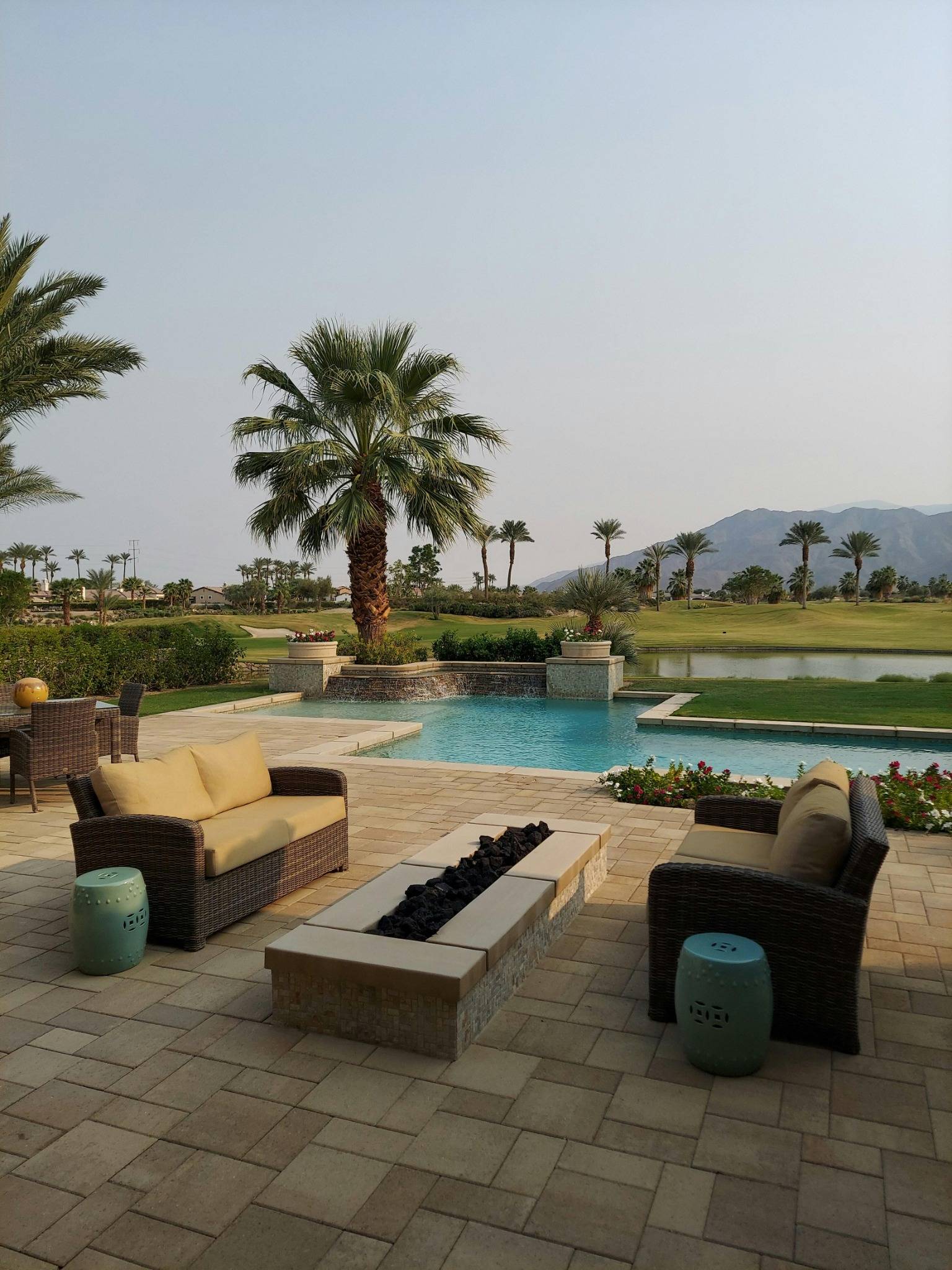 Modern Phoenix AZ home patio with plunge pool, waterfall feature, and indoor outdoor living