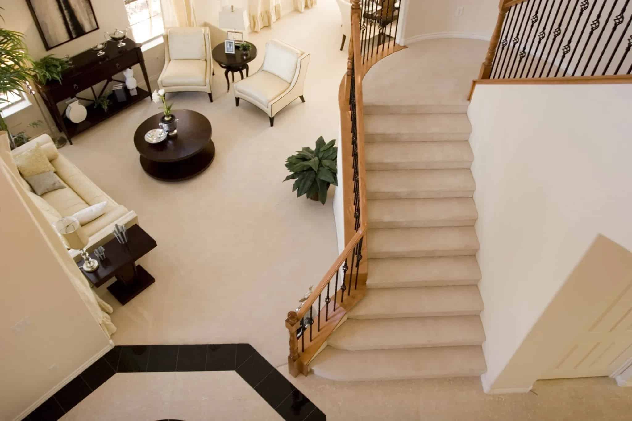 Home interior with staircase, open living area, and neutral tones