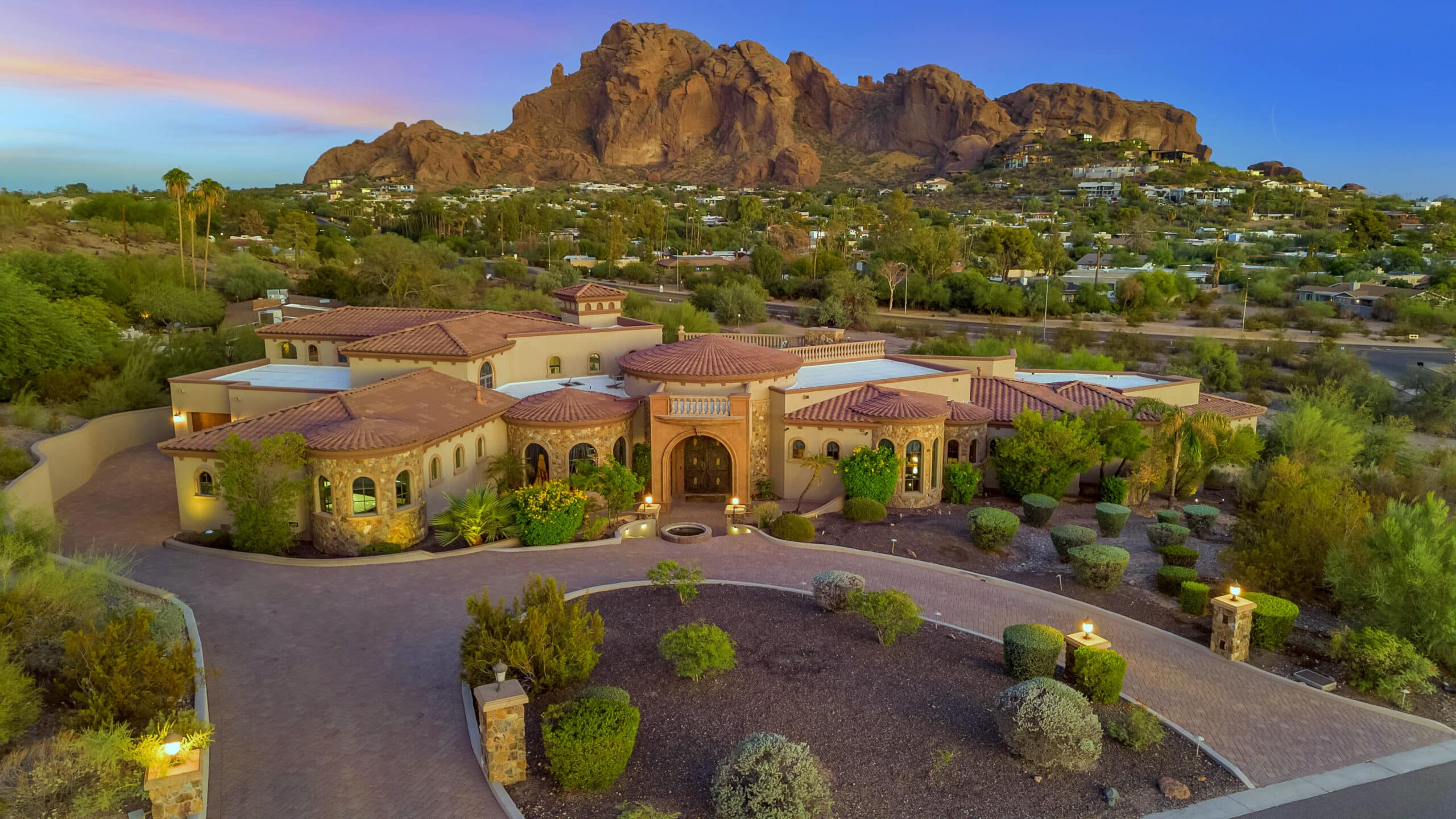 Luxury desert estate with mountain views, landscaped grounds, and upscale homes at sunset from desert-ridge-and-north-phoenix-communities